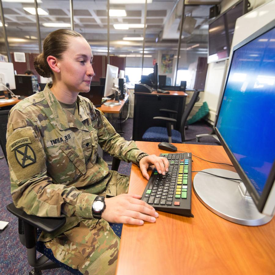 Veteran student at computer in uniform
